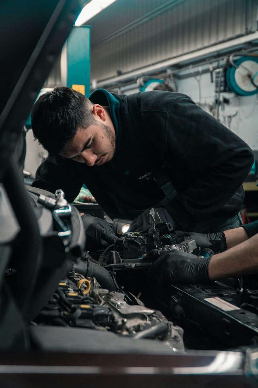 Pittsburgh Auto Repair Pros mobile mechanic diagnosing a car under the hood in Pittsburgh, PA
