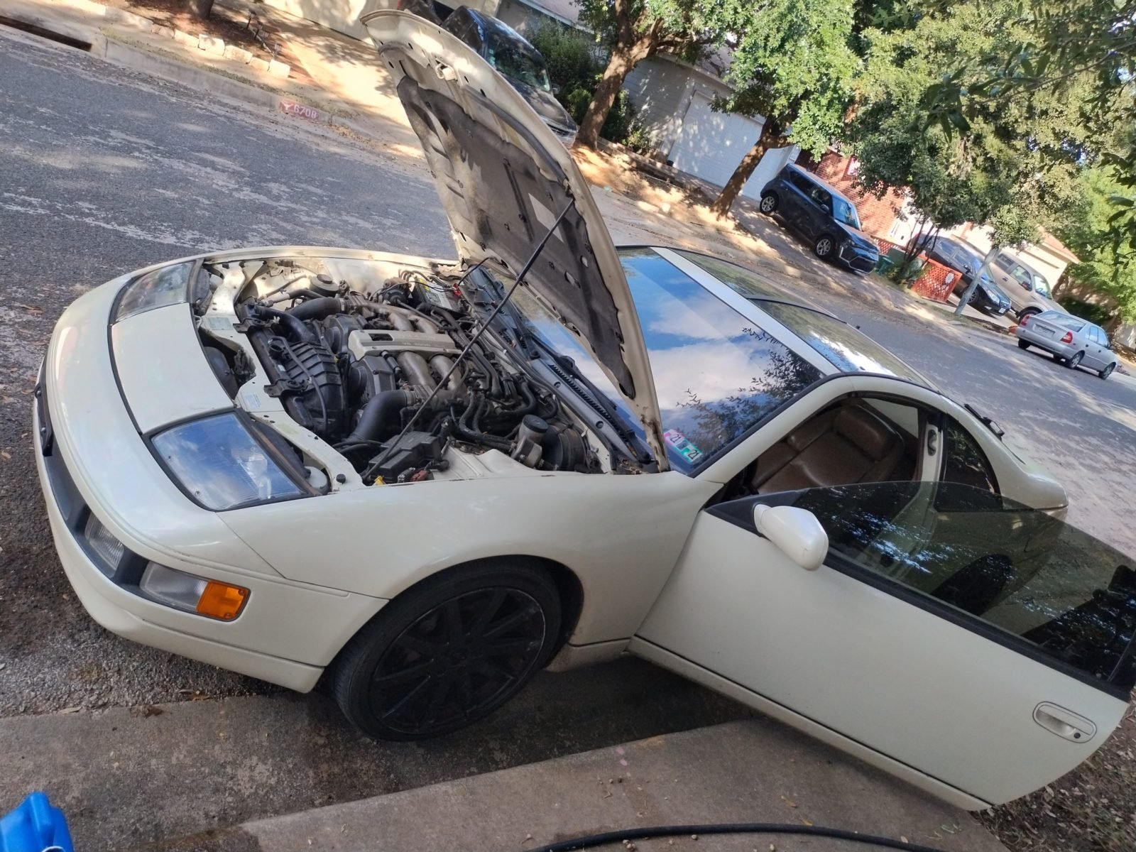 Mobile mechanic working on a car at a customer's home in Pittsburgh